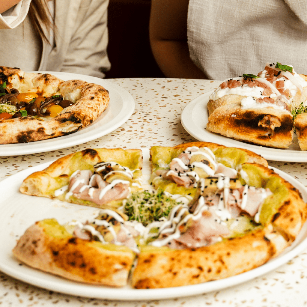 A close-up of a Fortuna pizza with a golden-brown, crispy crust.